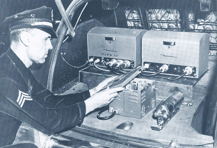 Patrol vehicle's radio equipment in 1950. Sgt. Terry Blackwood featured