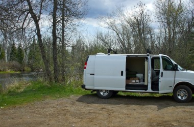 converted rv van by a river