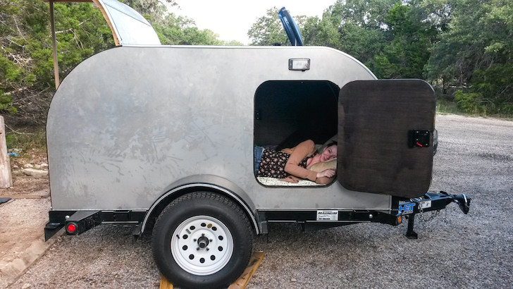 Girl testing out a tear drop camper