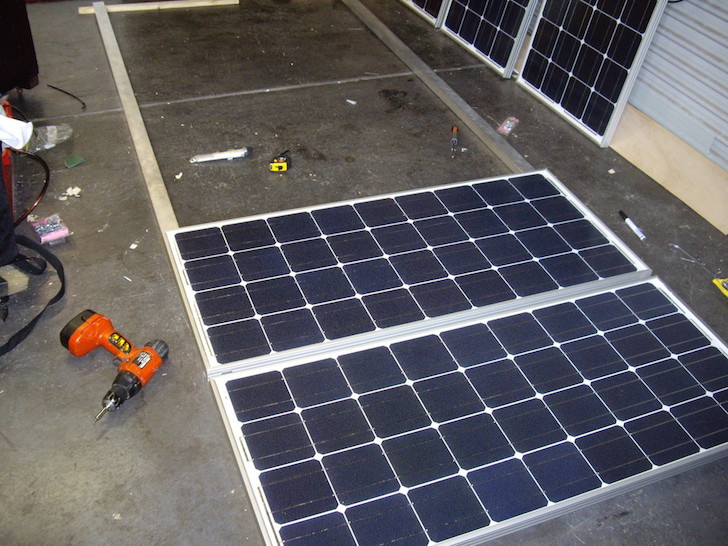 The solar panels are mounted on an aluminum tray for airflow