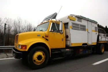 Yellow Shasta trailer on a flatbed truck
