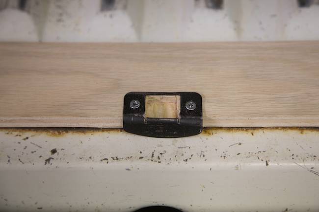 A simple household strike plate holds the latch in place