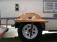 Table mounted between tire and wheel well