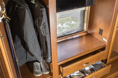 Clothes hung up and in drawers of an RV closet