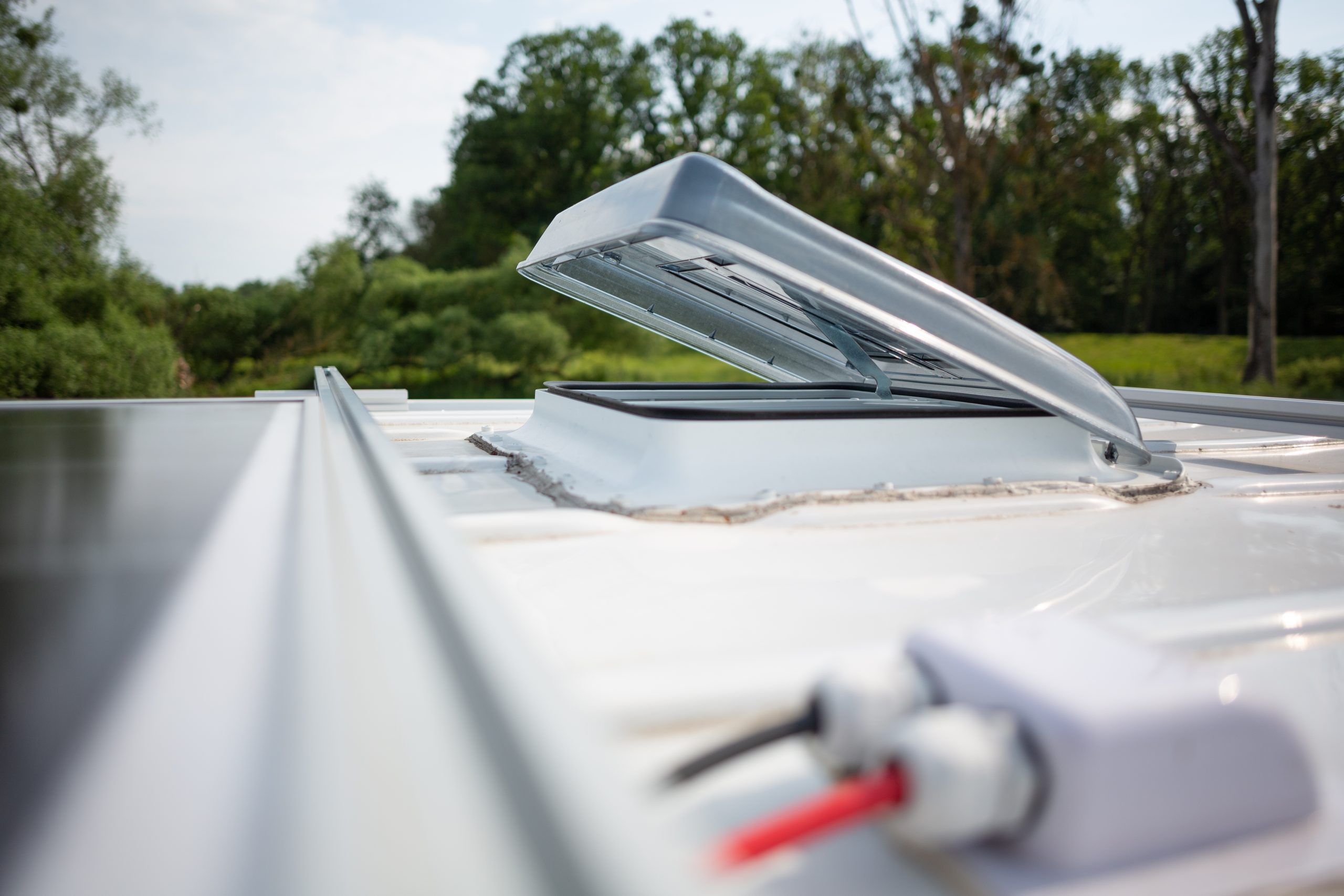 View of RV rubber roof with open vent cover