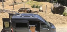Sprinter van conversion costs vary based on attributes like the solar panels on the roof of this dark gray converted van