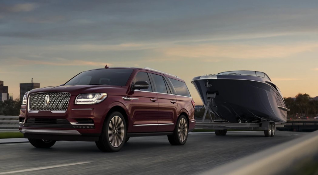 A Lincoln Navigator tows a boat.