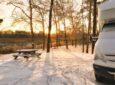 Motorhome in the snow with a sunrise