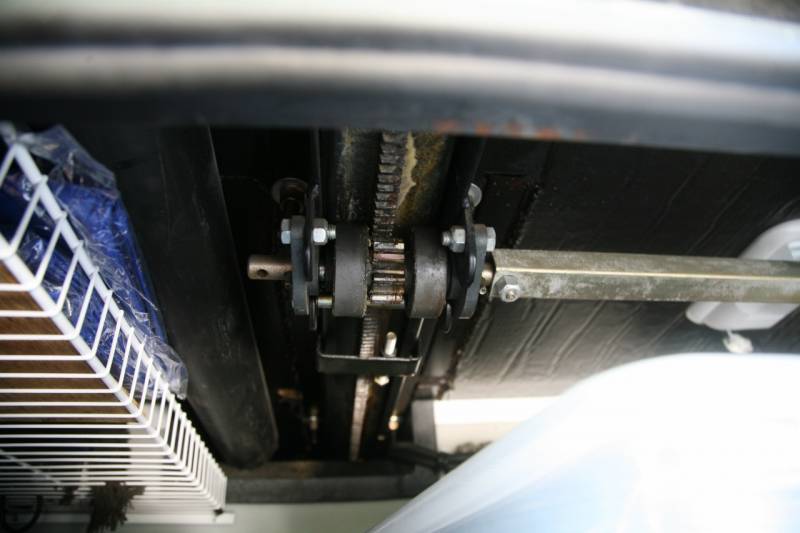View under an RV slide-out showing gears that operate the slide-out - RV slide-out maintenance