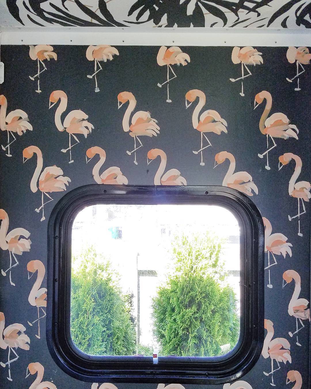 Unique RV interior paint ideas: hand painted flamingos on a black background