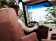 Women at the wheel of a motorhome driving down the road - RV captain's chairs