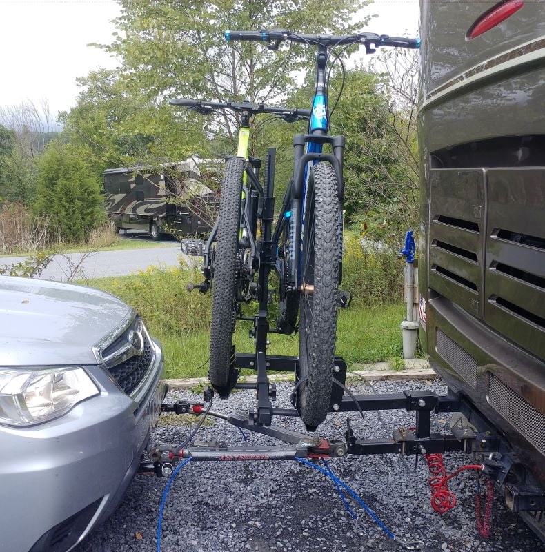 two bikes mounted on the back of a motorhome with an rv bike rack