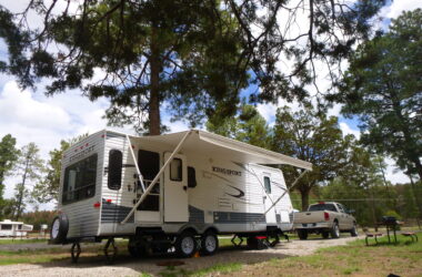 RV awning extended at campsite - feature image for How To Replace RV Awning Fabric