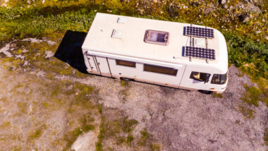 aerial view of RV with solar panels - feature image for How To Hook Up Solar Panels To RV Batteries