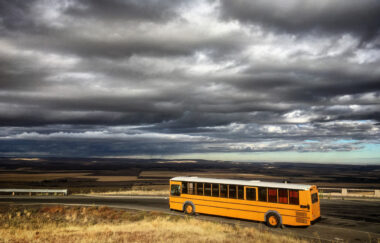 skoolie bus conversion in front of stormy clouds