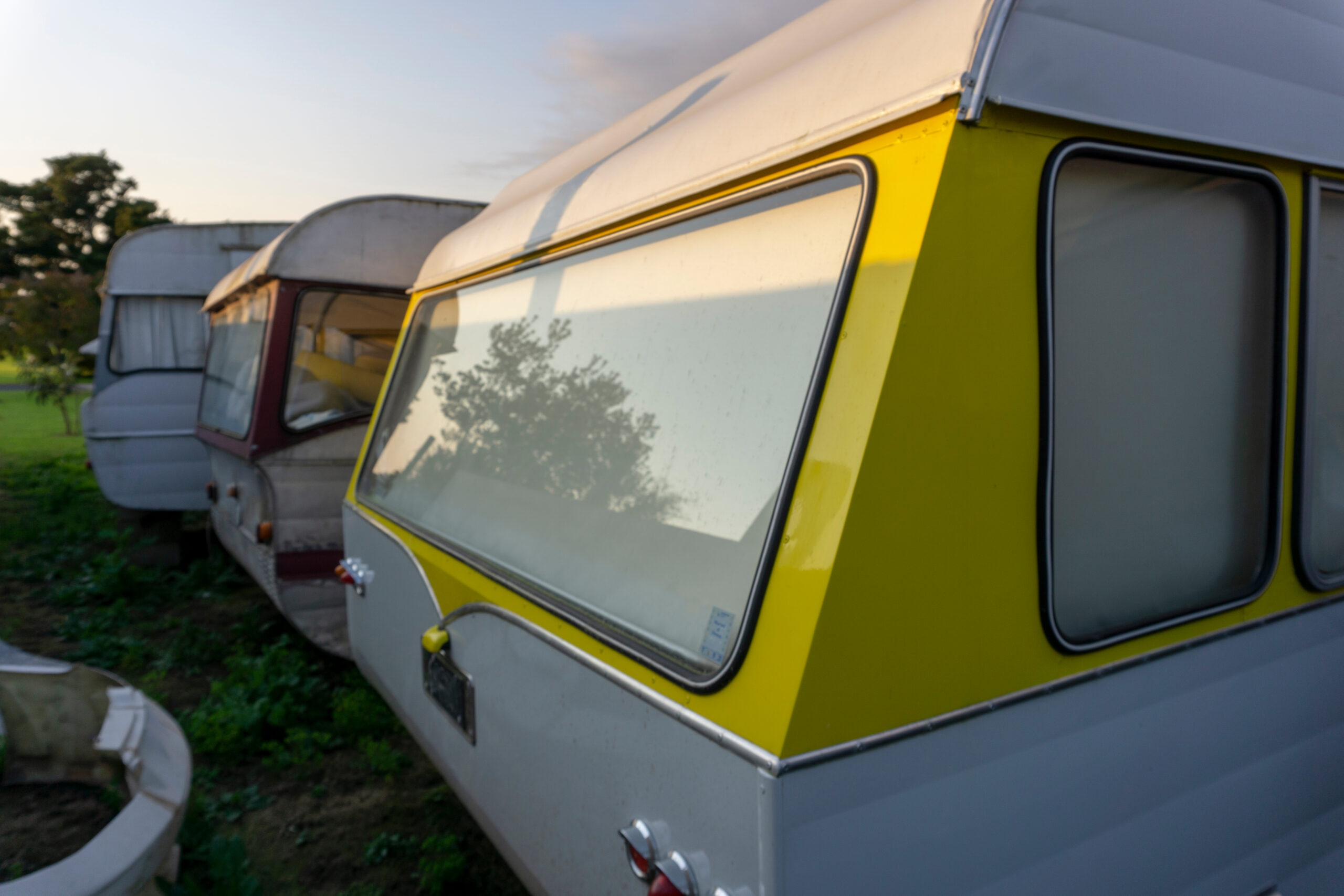 renovated vintage RVs in yard - feature image for Is There Money In Flipping RVs?