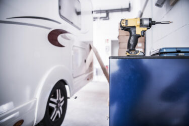 motorhome repair shop with a drill and RV