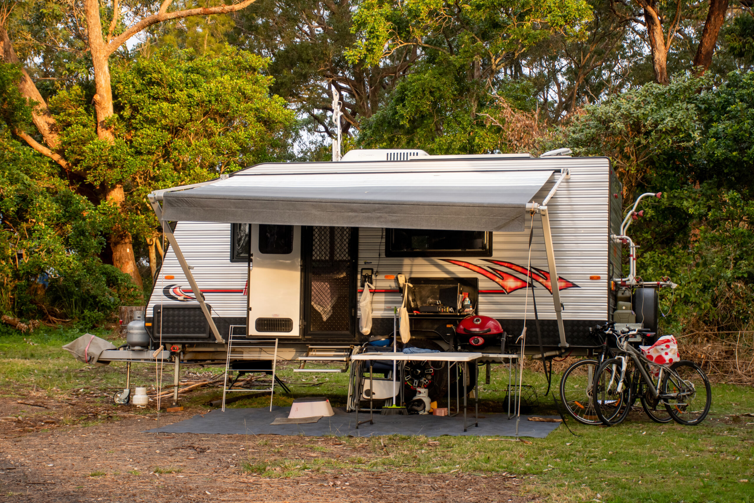 an RV with an RV awning at a campsite - feature image for How To Clean A Stained RV Awning