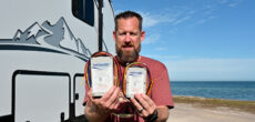 Chris Hinton of Hinton the Trail holds both the new and old softstart ac devices from Network RV.