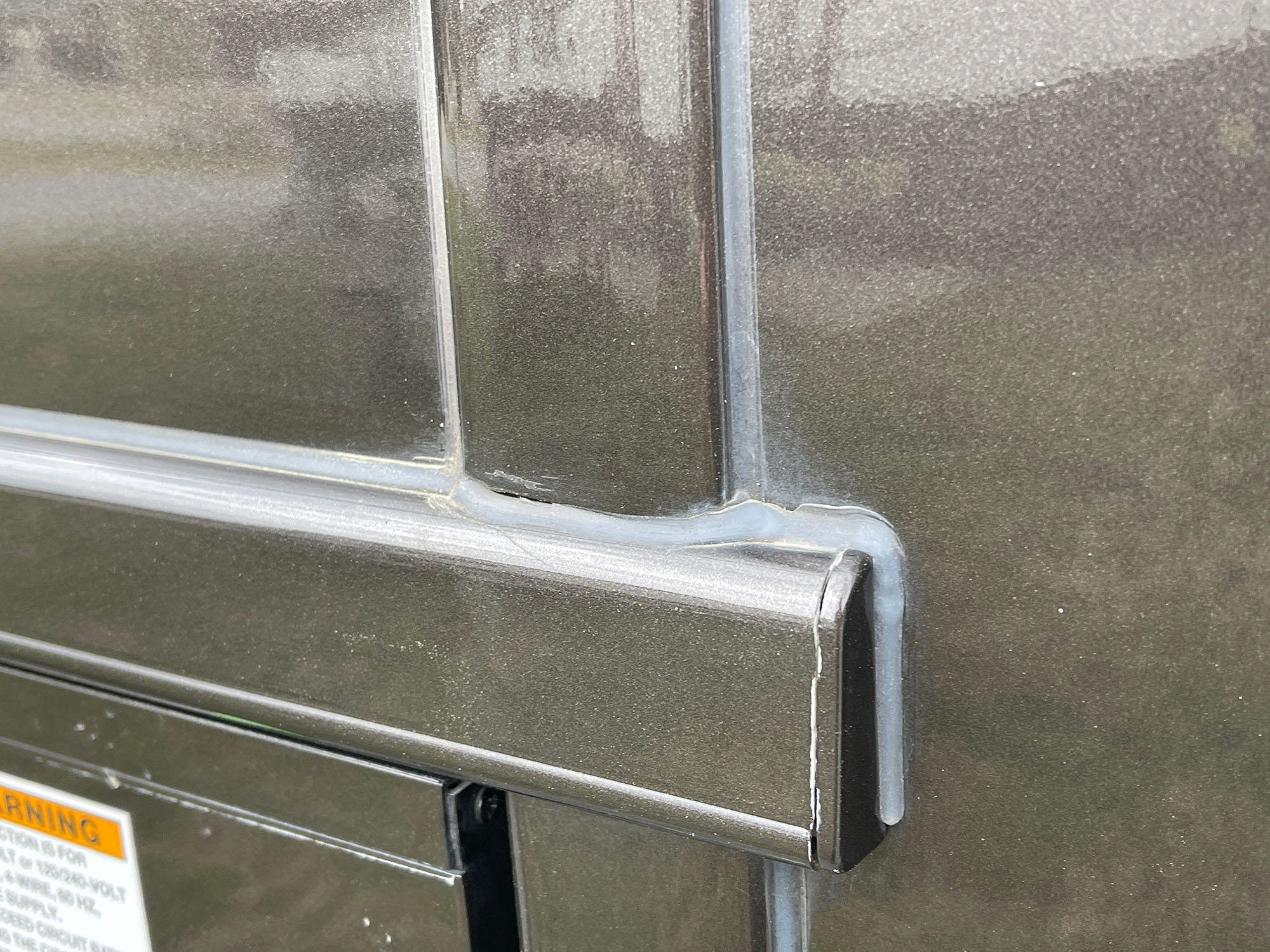 a close up view of caulk on the side of a motorhome