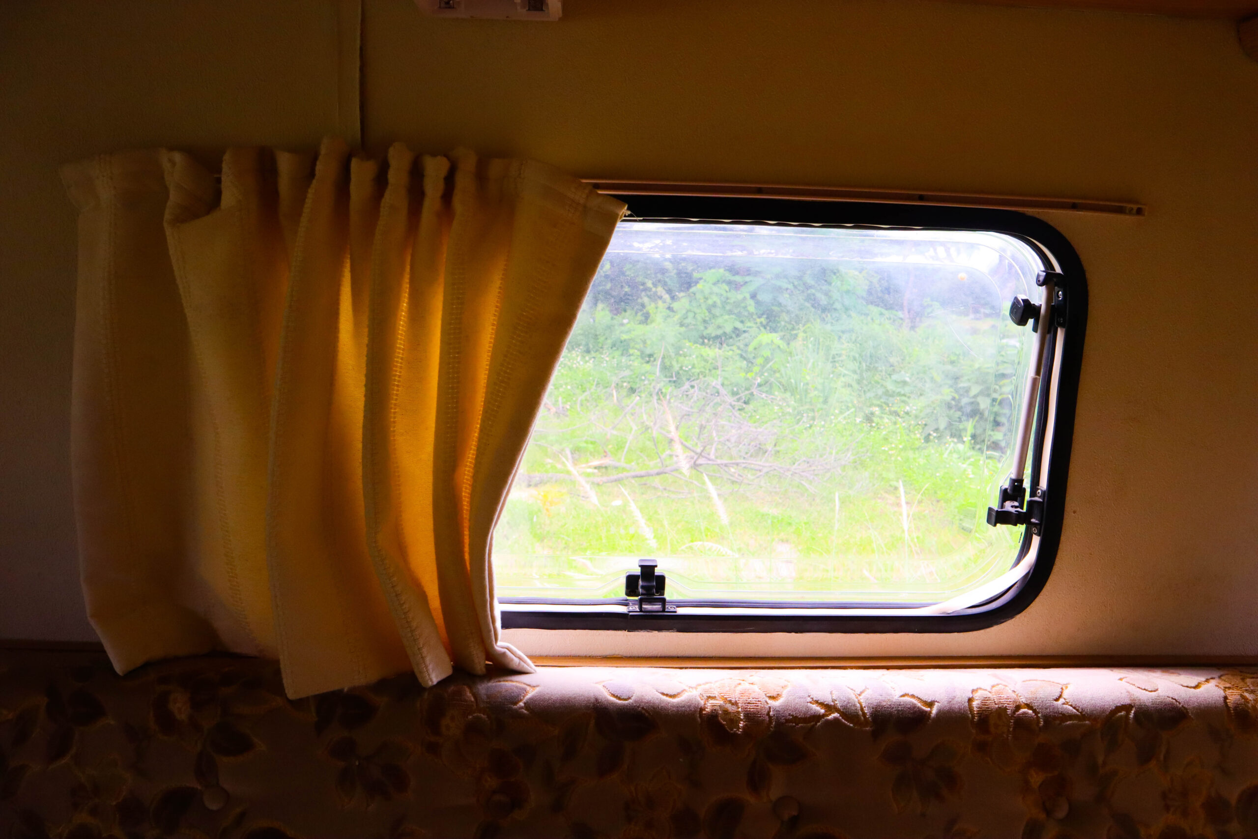 RV window with curtain and RV window rain guards