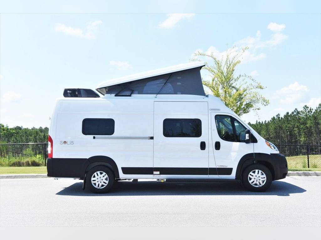 A white class B camper van in a paved lot like this one is a good reason to sell your rv right now.