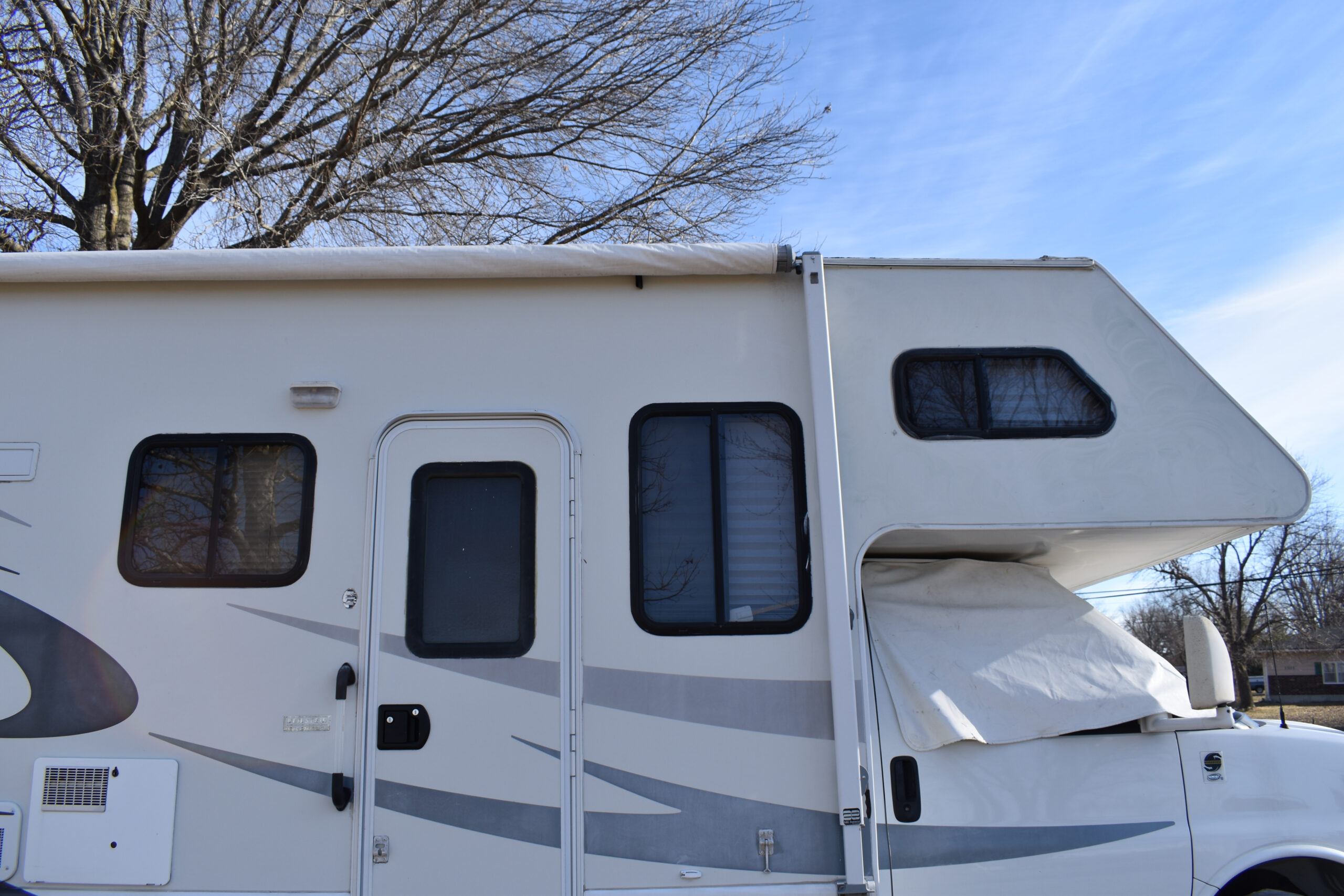 side view of RV motorhome - feature image for How To Drill Out An RV Lock