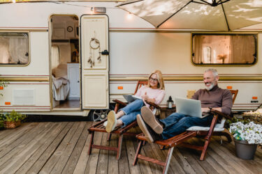 RV deck ideas with two RVers in front of camper