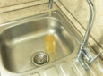 RV sink with dirty tap water - feature image for RV hot water smells