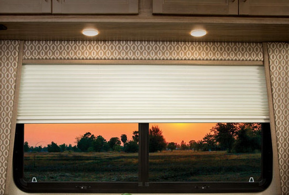 Sunset showing through an RV window with pleated shade