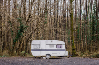 old trailer in forest by itself - feature image for old RVs