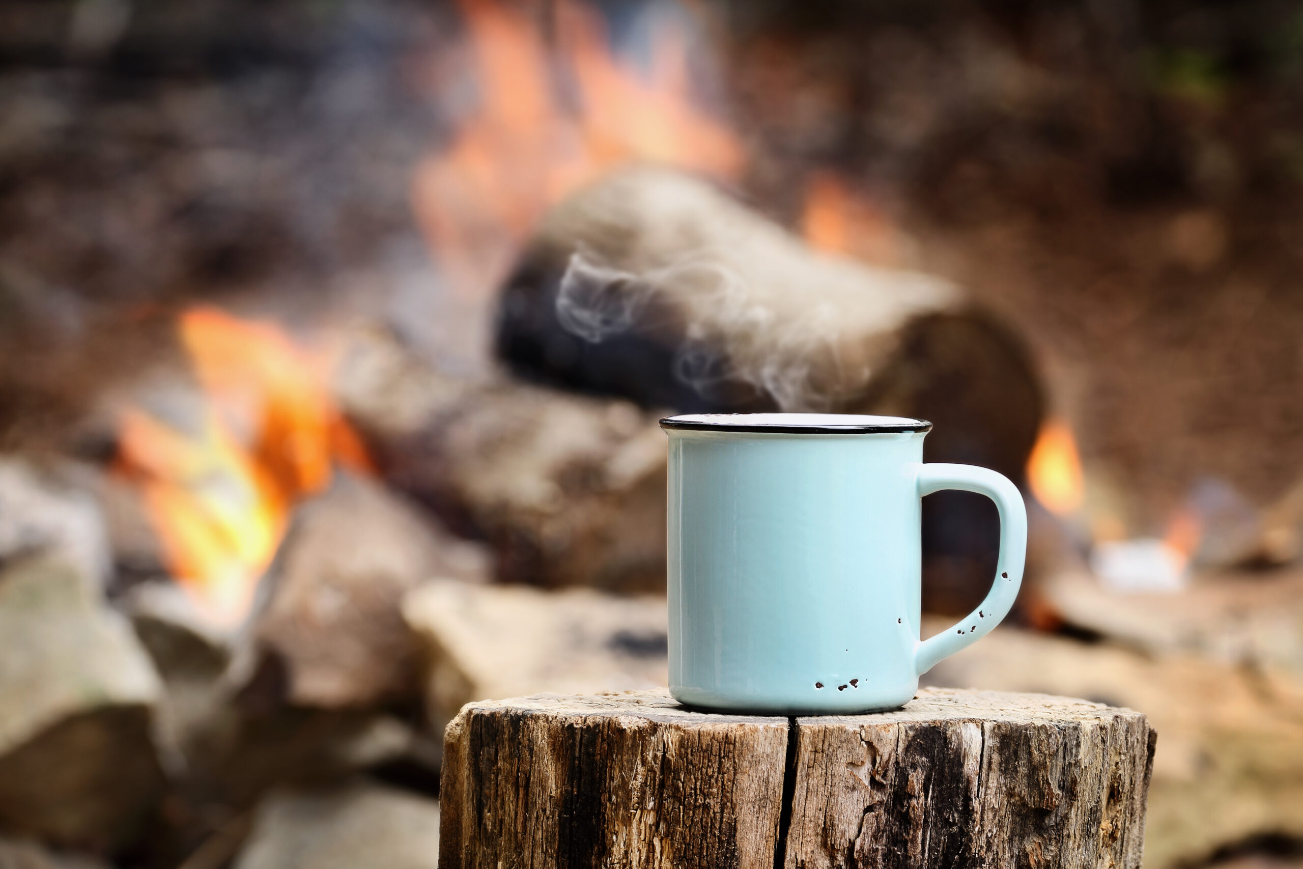 coffee in front of campfire - feature image for camping breakfast ideas