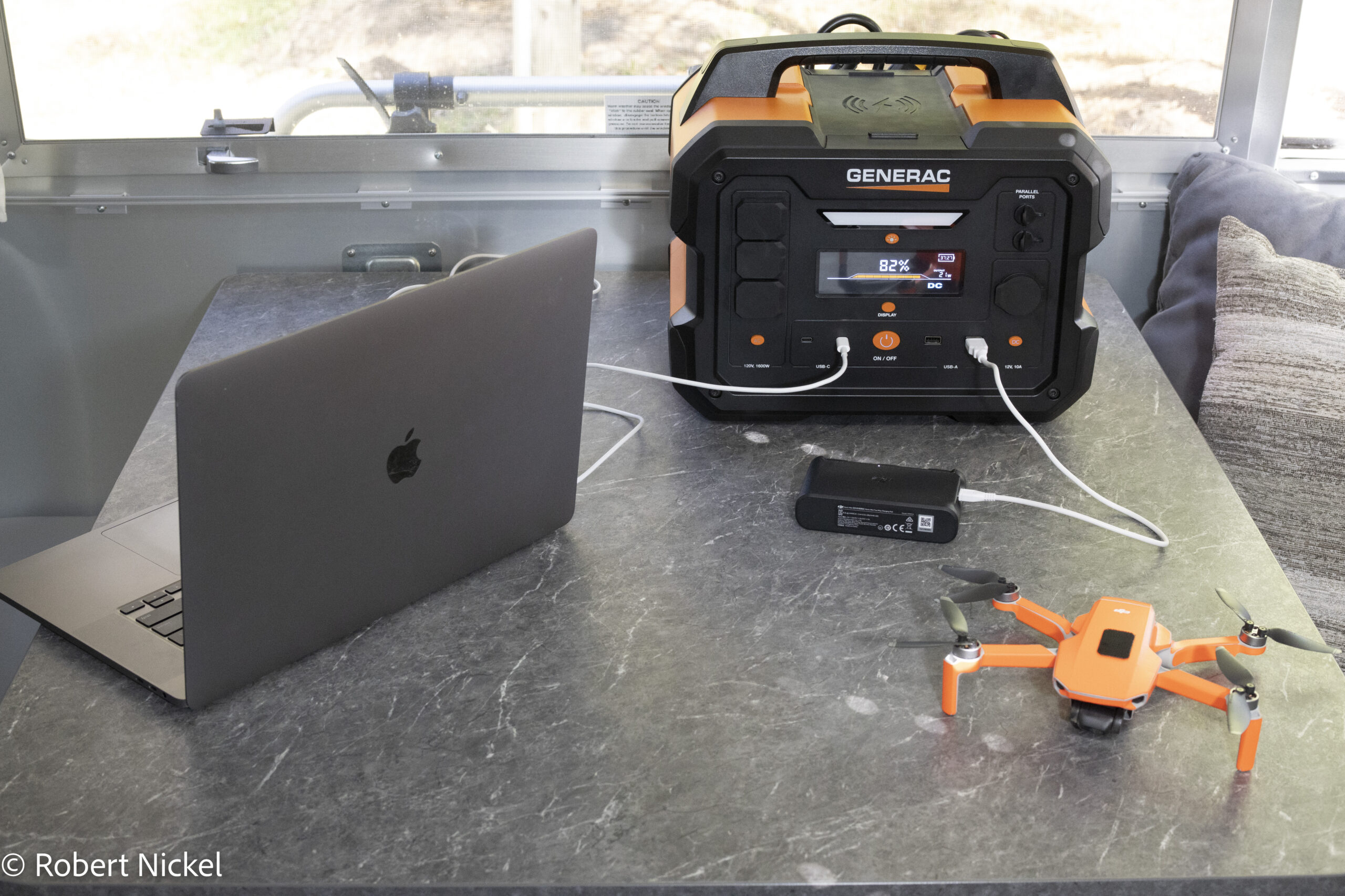 GENERAC GB1000 portable power station with laptop and drone control plugged in.