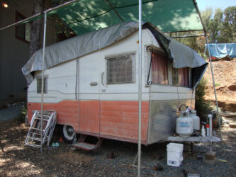 vintage camper with an RV tarp