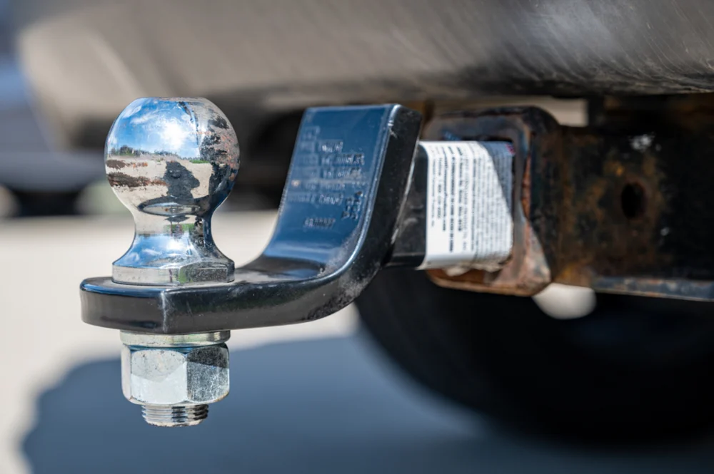 Close up of a trailer hitch ball on a tow vehicle