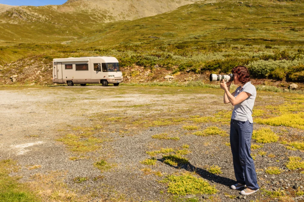 person taking a photo in front of RV - feature image for travel pictures