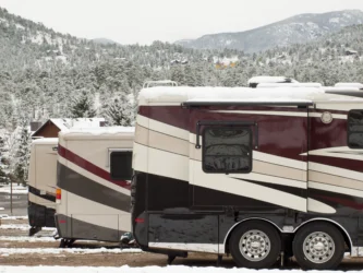 RVs camping in winter storm - feature image for how to keep RV pipes from freezing while camping
