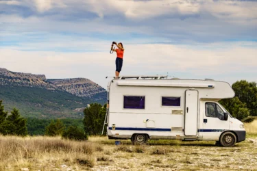 photographer in front of RV - feature image for ways to display travel photos in RV