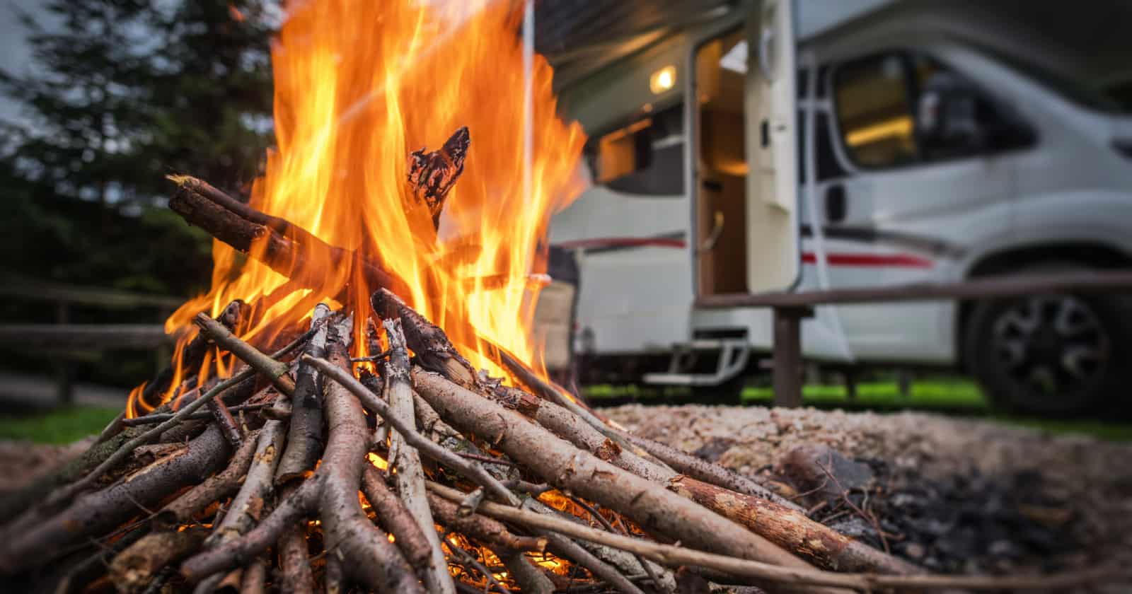 campfire and RV in one of the cheap camping sites