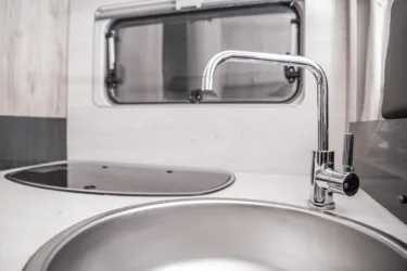 faucet in RV, feature image for sanitize RV fresh water tank