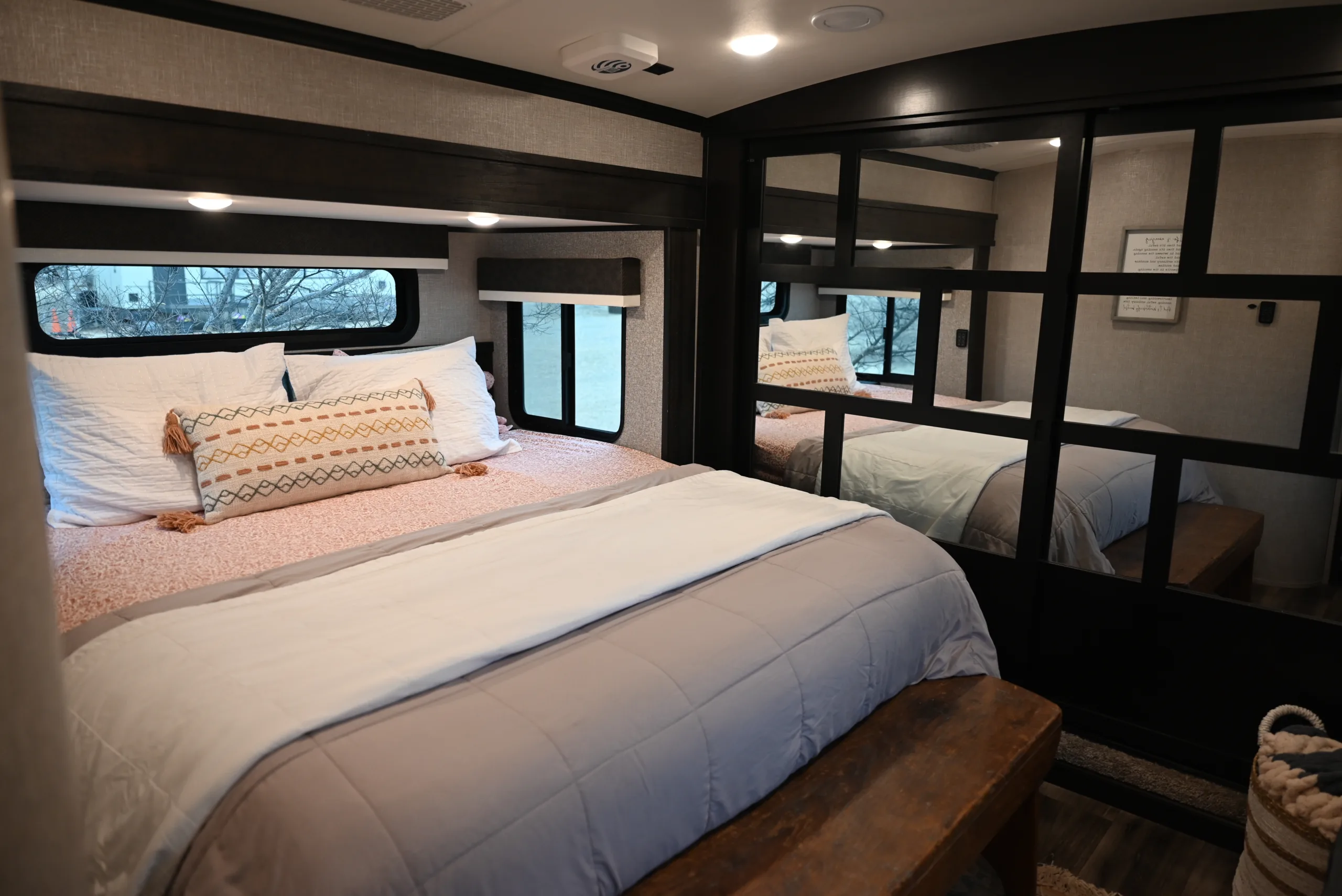 images for springtime rV renovations, a bed sitting inside of a bedroom on top of a white bed covered in a white bedspread