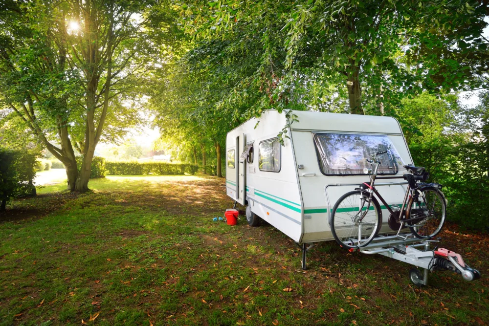 Unhitched travel trailer with bicycle.