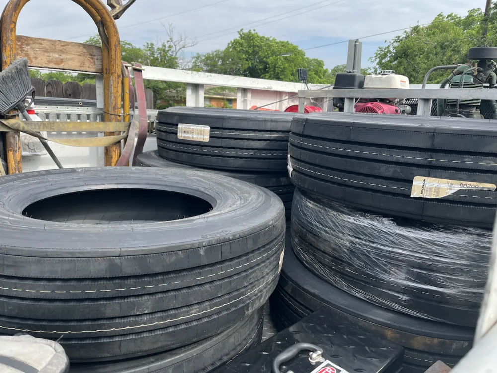 Eight Michelin tires on a mobile RV tire replacement truck ready to be installed.