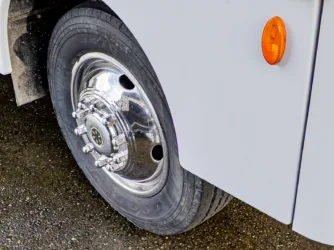 a close up of a white truck tire with a bright orange light on the side of the truck tire, RV tires