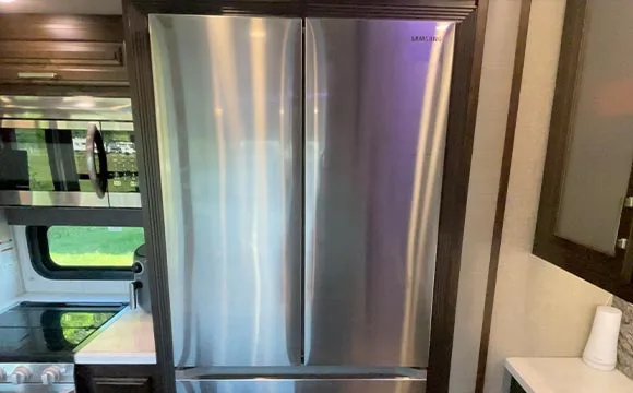 A residential fridge installed in an RV.