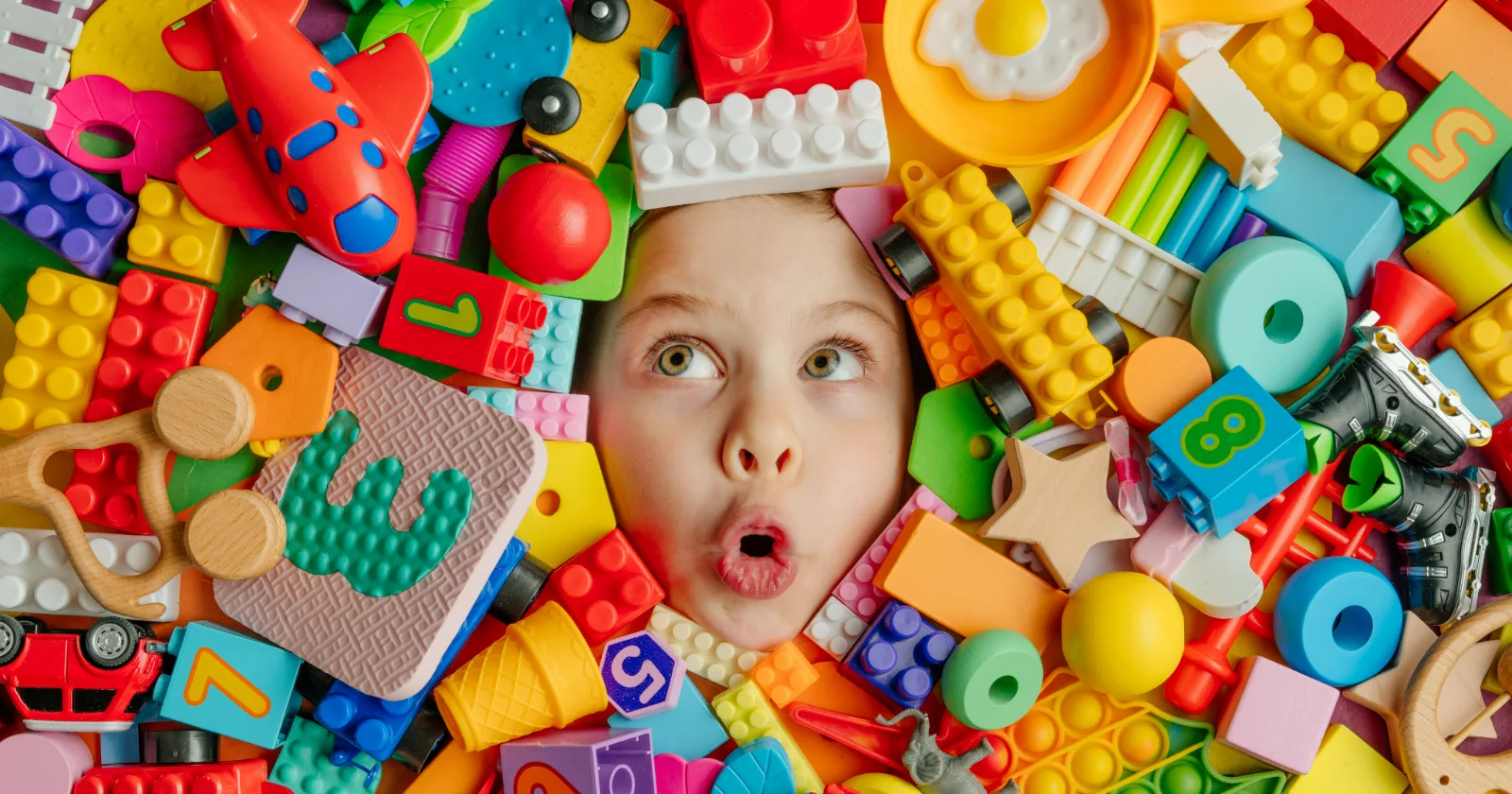 Kid's face surrounded by building blocks.