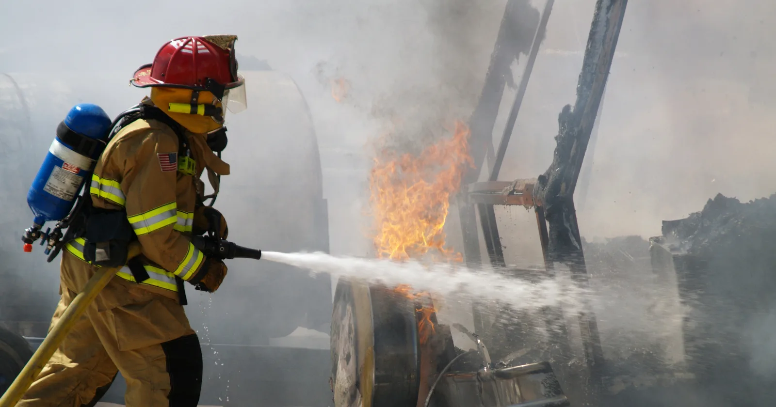 Shot of a firefighter putting out a burning RV