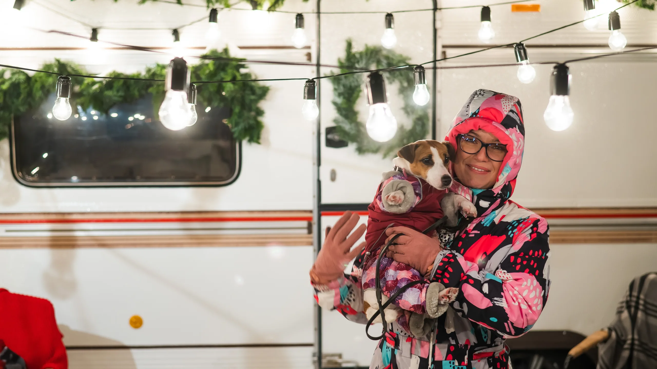 festive woman RVer with dog makes her RV feel like home (Image: Shutterstock)