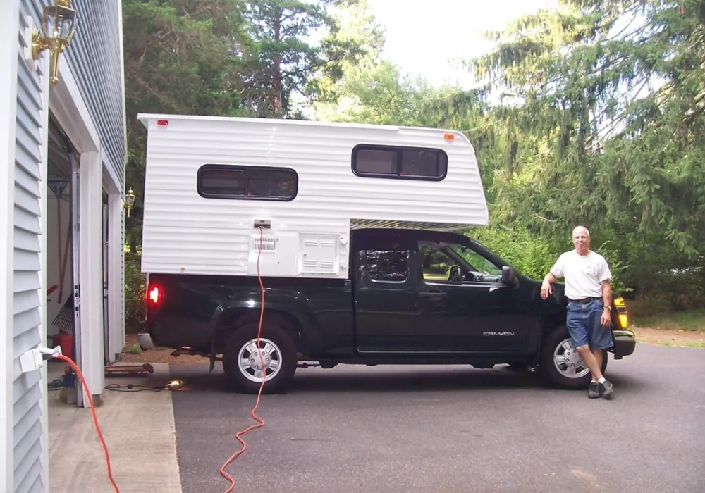 Bruce standing next to his truck camper build