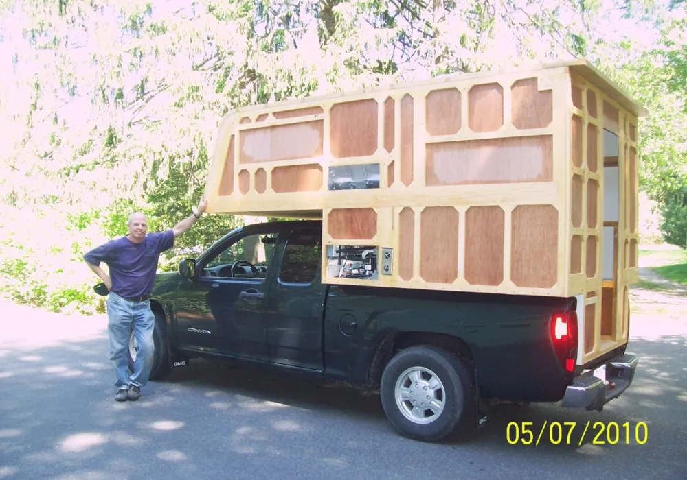 camper frame set up in bed of truck with Bruce standing next to it